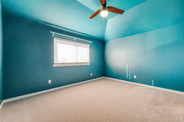 carpeted spare room with ceiling fan, a textured ceiling, and vaulted ceiling