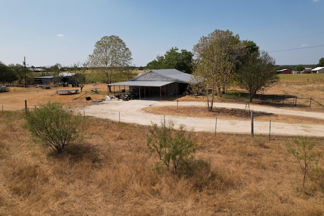 view of yard featuring a rural view and an outdoor structure