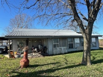 view of front of house with a front lawn and a carport