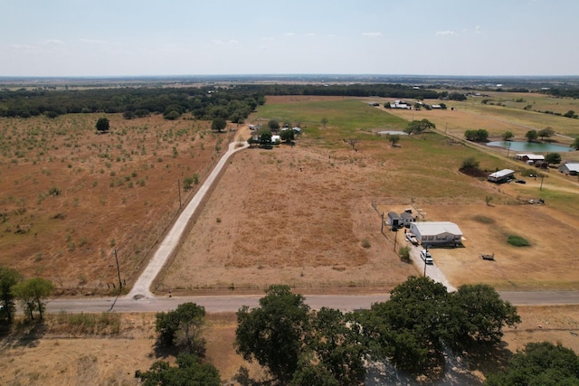 birds eye view of property featuring a rural view and a water view