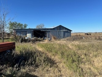 view of outdoor structure with a rural view