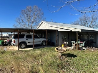 view of property exterior featuring a carport