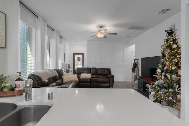 kitchen featuring hardwood / wood-style floors, ceiling fan, a healthy amount of sunlight, and sink