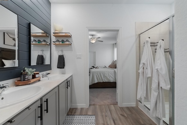 bathroom featuring hardwood / wood-style floors, ceiling fan, curtained shower, and vanity