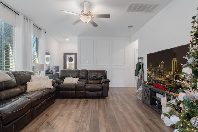 living room featuring ceiling fan and light hardwood / wood-style floors