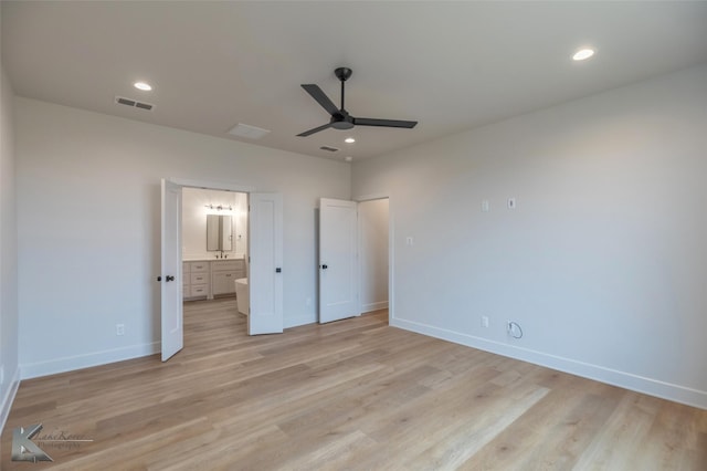 unfurnished bedroom featuring connected bathroom, ceiling fan, and light hardwood / wood-style floors