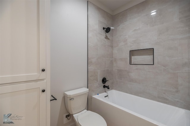 bathroom featuring toilet and tiled shower / bath combo