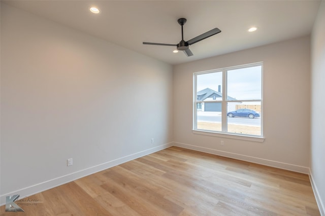 spare room with ceiling fan and light wood-type flooring