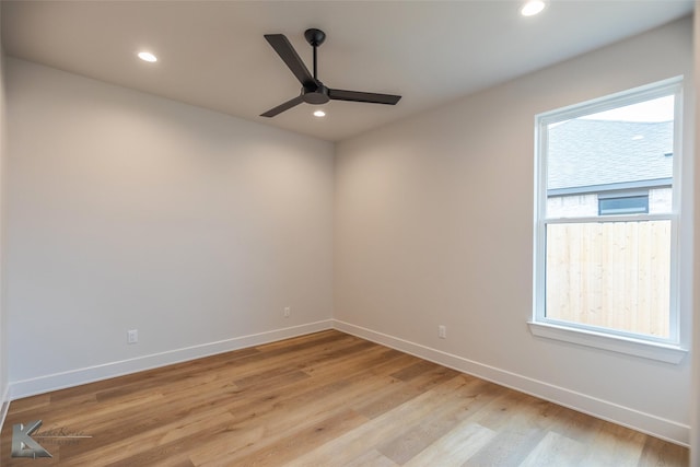 empty room with ceiling fan, plenty of natural light, and light hardwood / wood-style floors