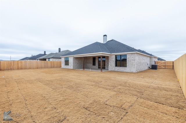 back of property with a patio and central air condition unit