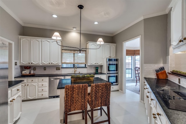 kitchen with white cabinets, light tile patterned floors, sink, and appliances with stainless steel finishes