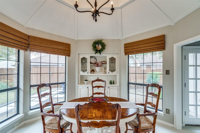 dining space with plenty of natural light, light tile patterned floors, and a notable chandelier