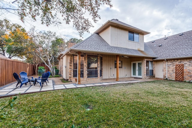 back of property featuring a lawn and a patio area