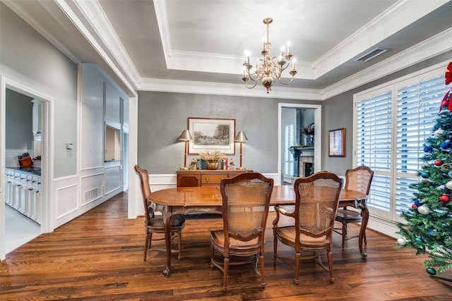 dining area featuring dark hardwood / wood-style floors, plenty of natural light, and an inviting chandelier