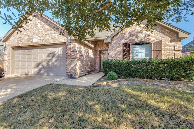 view of front of home with a front yard and a garage