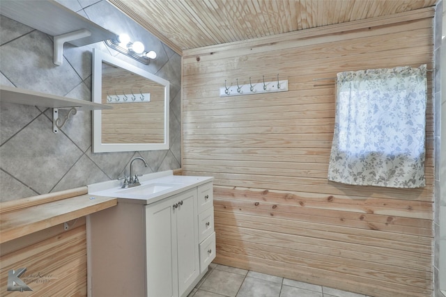 bathroom featuring tile patterned floors, wood walls, vanity, and wooden ceiling