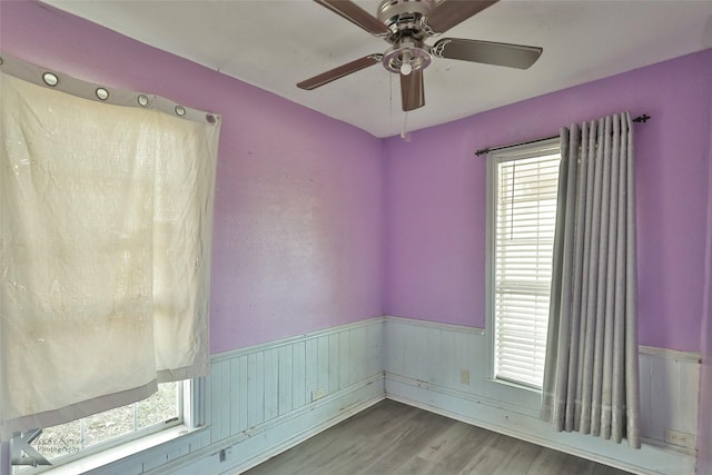 empty room with hardwood / wood-style flooring and ceiling fan