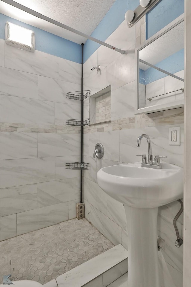 bathroom with a wall unit AC, decorative backsplash, and tiled shower