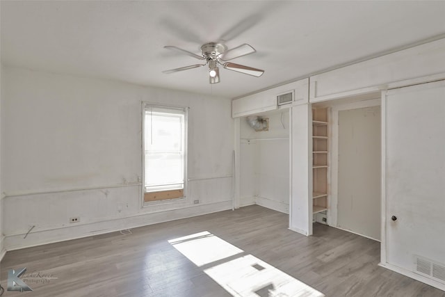 unfurnished bedroom featuring ceiling fan, a closet, and light hardwood / wood-style floors