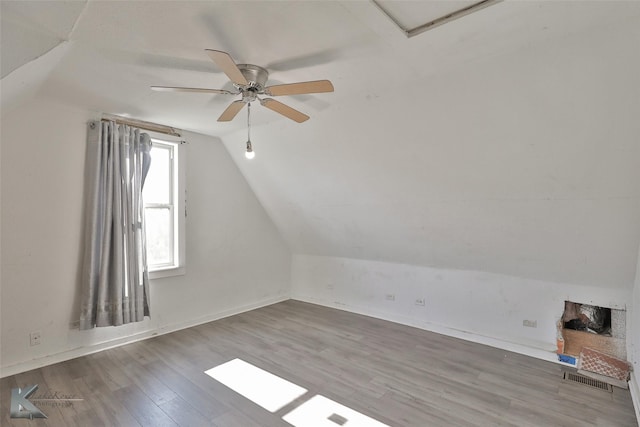 additional living space featuring ceiling fan, lofted ceiling, and hardwood / wood-style flooring