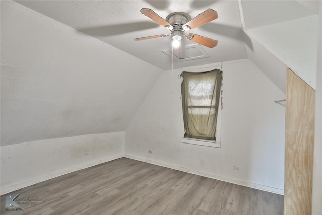 additional living space featuring ceiling fan, wood-type flooring, and lofted ceiling