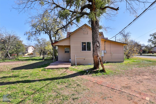 rear view of property featuring a yard