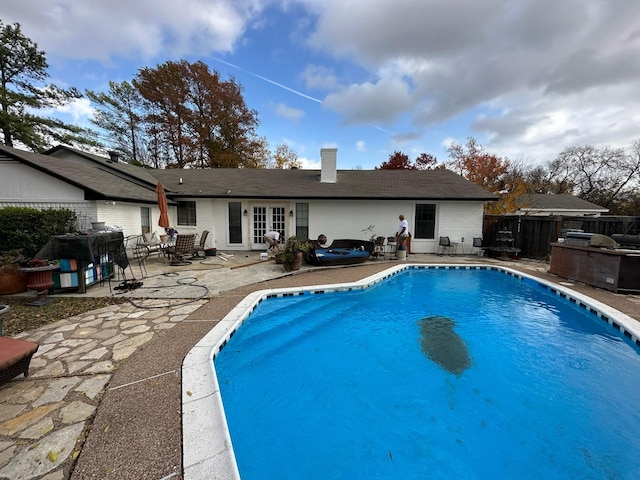 view of swimming pool featuring a fenced in pool, a patio, and fence