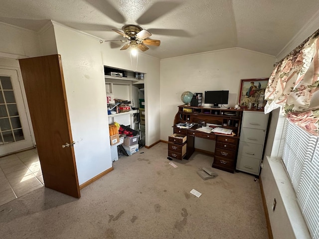 carpeted home office with ceiling fan, vaulted ceiling, ornamental molding, and a textured ceiling