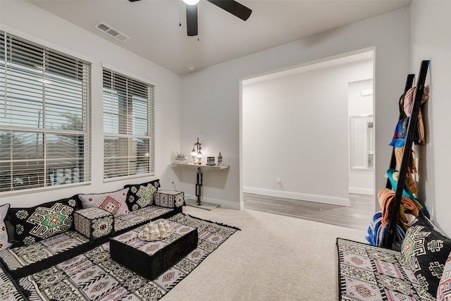 living room featuring ceiling fan and carpet