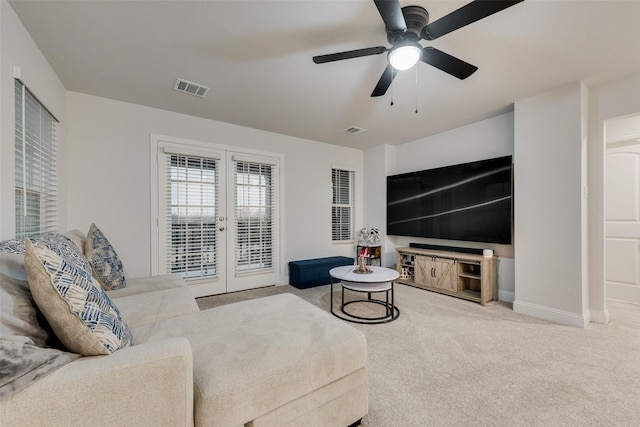 living room featuring carpet flooring, ceiling fan, and french doors