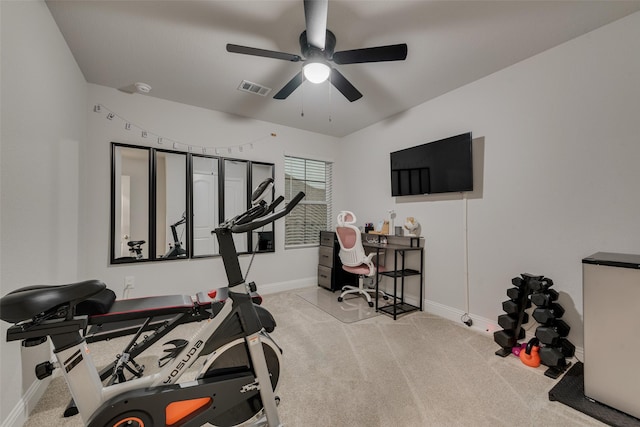 workout area featuring light carpet and ceiling fan