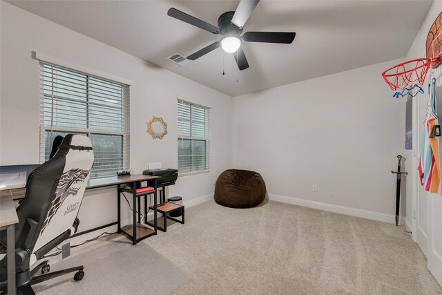 carpeted office space with ceiling fan