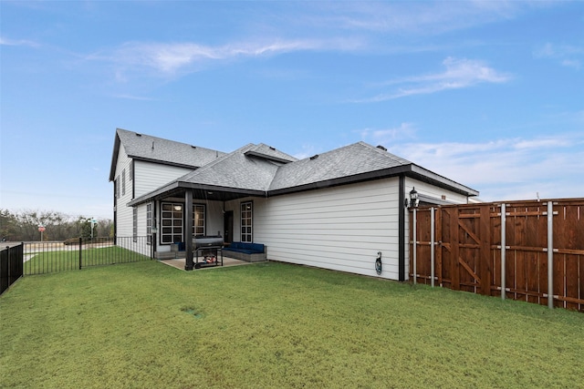 rear view of property with a lawn and a patio