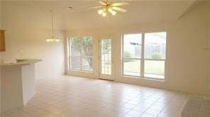 unfurnished living room featuring ceiling fan with notable chandelier