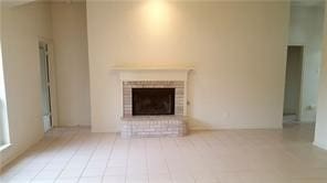 unfurnished living room featuring a brick fireplace