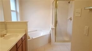 bathroom featuring tile patterned floors, vanity, and shower with separate bathtub