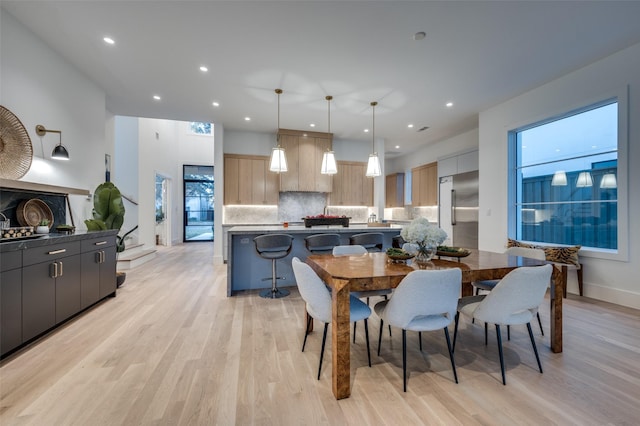 dining area featuring a wealth of natural light and light hardwood / wood-style floors