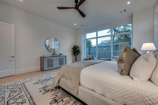 bedroom with hardwood / wood-style floors and ceiling fan