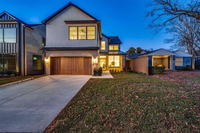 view of front of home featuring a garage and a lawn