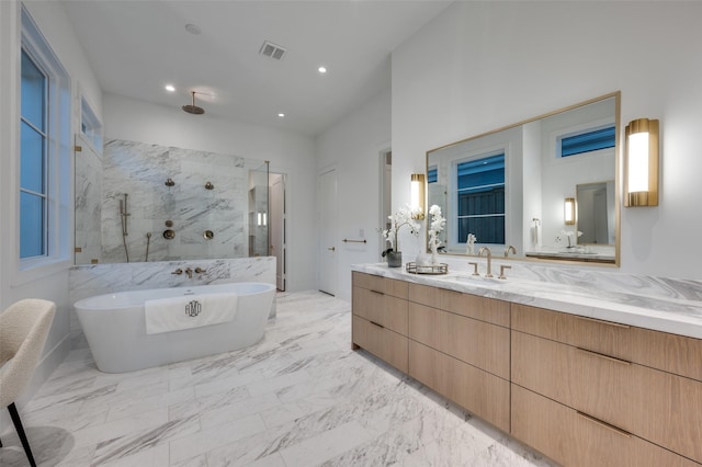 bathroom featuring shower with separate bathtub and vanity