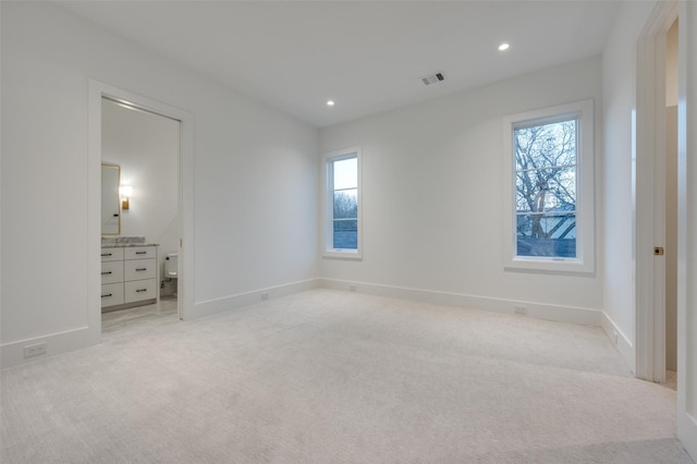 unfurnished bedroom with light colored carpet