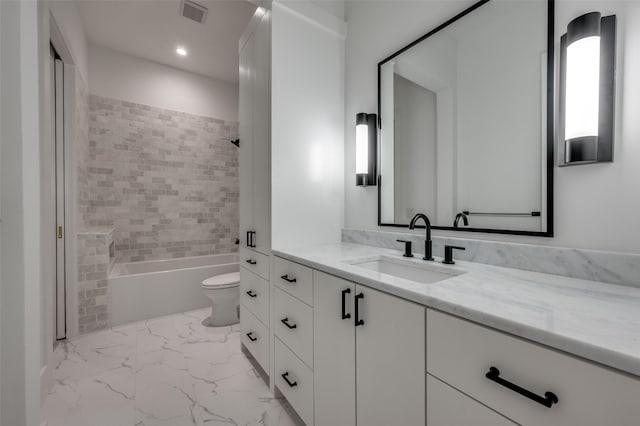 full bathroom with vanity, tiled shower / bath combo, and toilet