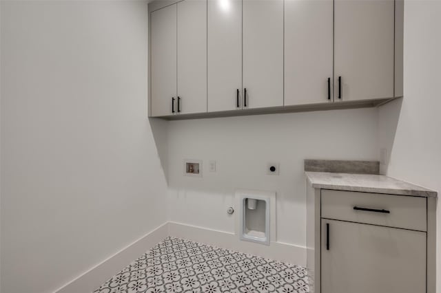 clothes washing area featuring electric dryer hookup, gas dryer hookup, cabinets, and washer hookup