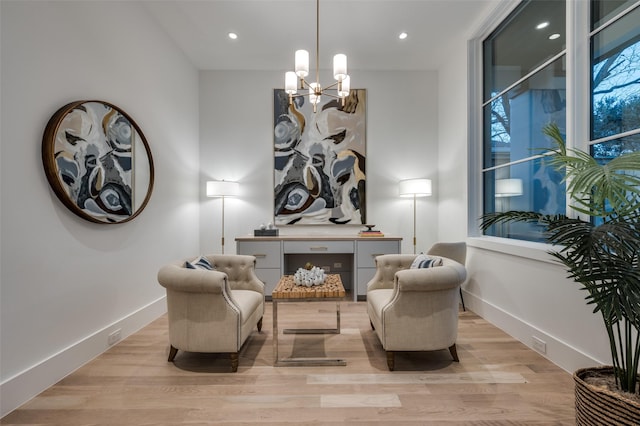 sitting room with an inviting chandelier and light wood-type flooring