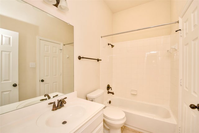 full bathroom with toilet, vanity, and tiled shower / bath