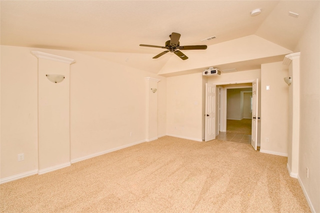 carpeted empty room with ceiling fan and vaulted ceiling