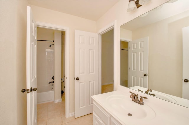 bathroom with tile patterned flooring, vanity, and tiled shower / bath