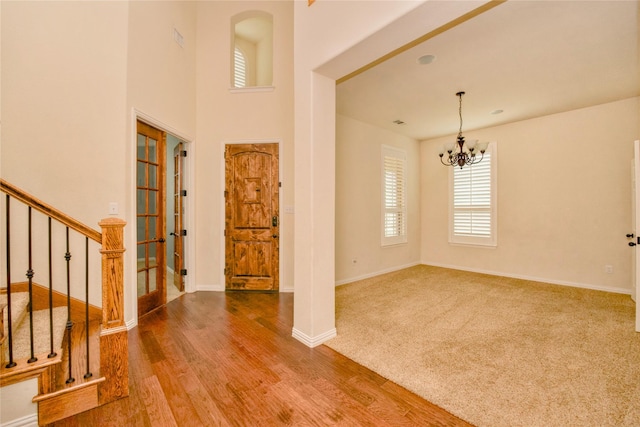 foyer featuring wood-type flooring and a chandelier