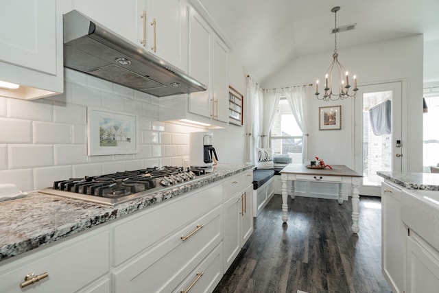 kitchen featuring decorative backsplash, white cabinetry, dark hardwood / wood-style floors, and stainless steel gas cooktop