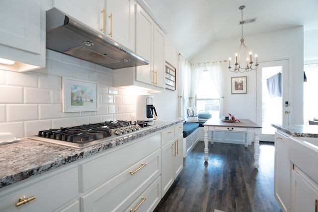 kitchen featuring white cabinets, backsplash, and stainless steel gas stovetop